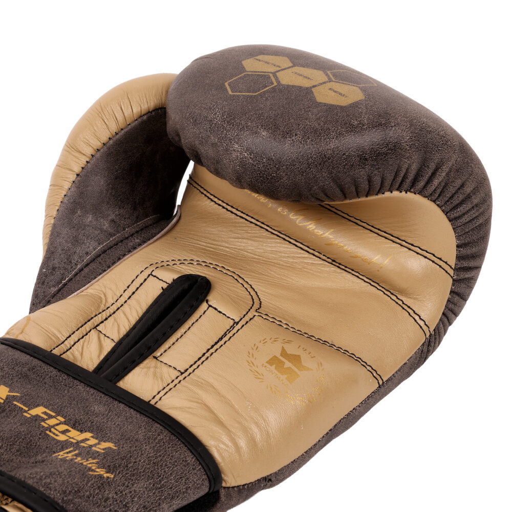 Détail macro du gant de boxe Montana X-FIGHT Evo Héritage : paume en cuir beige contrastée avec le dessus marron et hexagones dorés.
