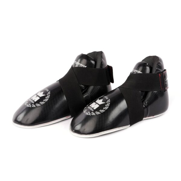 Protège-pieds noirs FOOTGUARD en PolyComposite avec mousse préformée, bande élastique en X et homologation CE, idéal pour le MMA et le kick-boxing.