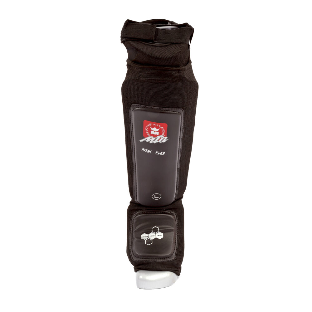 Protège tibias MK50 Absorb noir avec coup de pied intégré, mousse dense et renforts, conçu pour une absorption maximale pendant les entraînements intensifs.