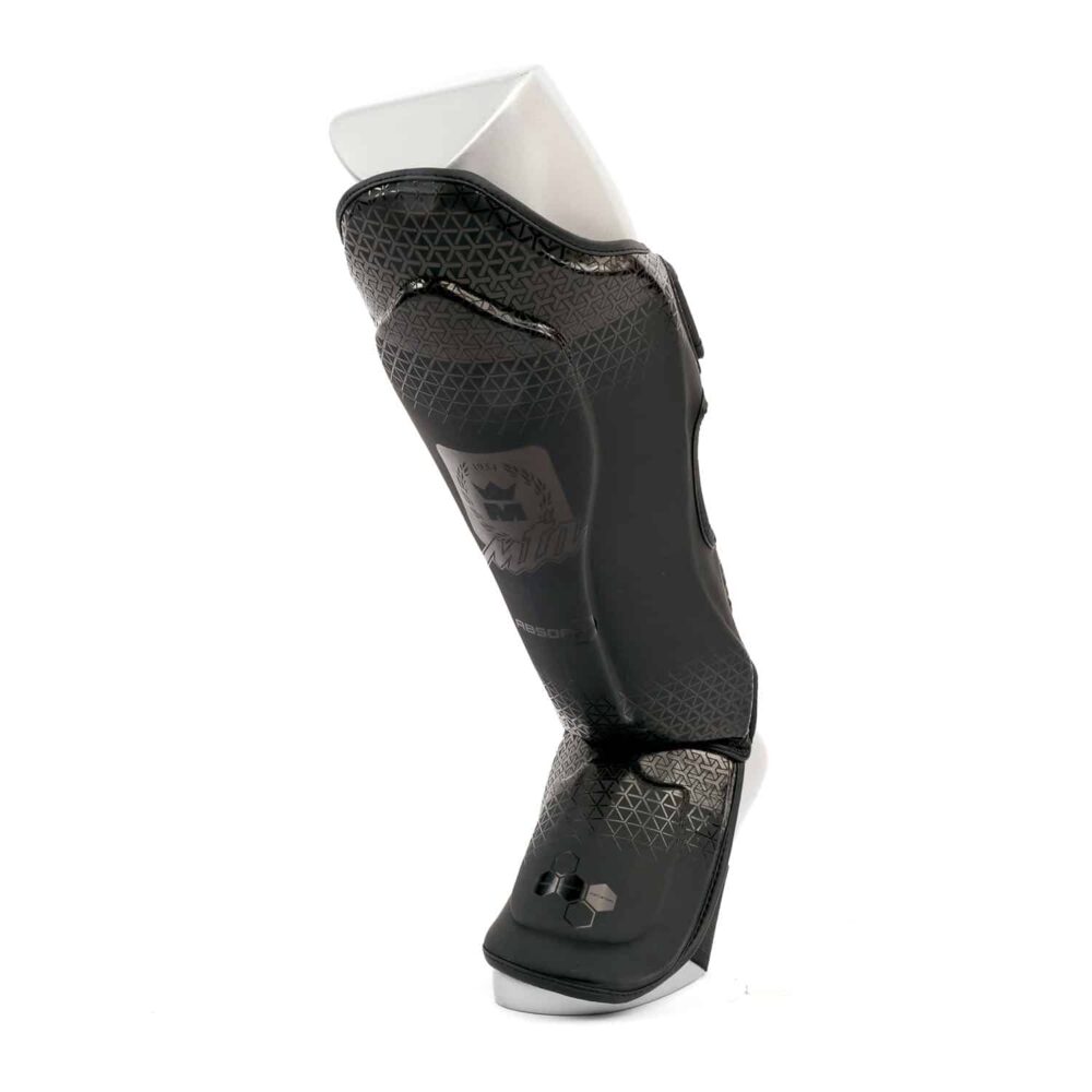 Protège tibias Stealth MK PROTECT en PolyComposite avec mousse renforcée, doublure antibactérienne et fermeture scratch, conçu pour les entraînements intensifs, certifié CE.